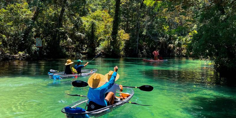 Kayakers paddle through the clear waters of Weeki Wachee River in Florida, enjoying a day on the water.