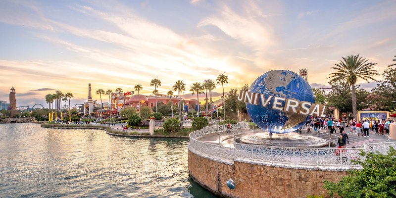 Universal Orlando's new water park features colorful slides and a large wave pool filled with excited visitors enjoying the sun.