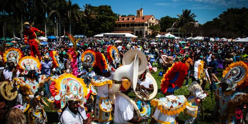 People in festive attire and large hats at the Deering Seafood Festival.