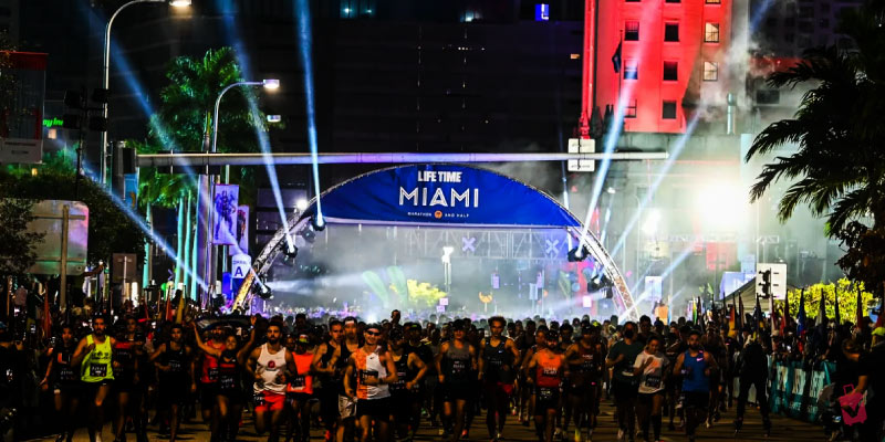 Runners start the Life Time Miami Marathon at night.