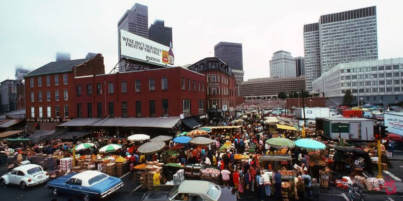 Busy crowds browse fresh produce stalls at the historic boston haymarket, an open-air market that has been a city staple for centuries.