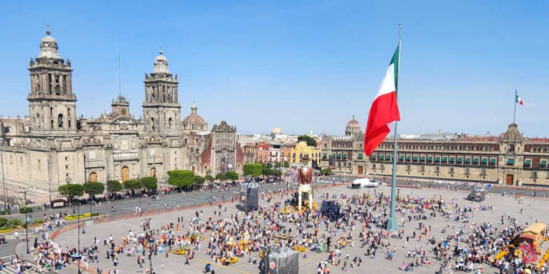 Centro Histórico of Mexico City, a bustling Zocalo square with a large Mexican flag and historic cathedral.