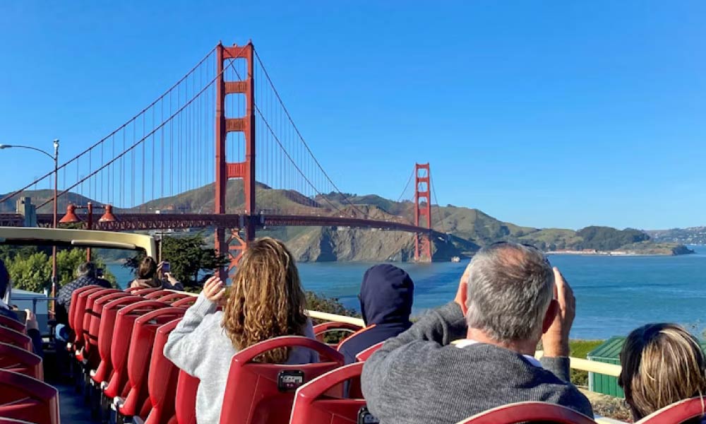 Tourists on a bus look at the Golden Gate Bridge, one of the exciting things to do in the San Francisco Bay Area to make your day.