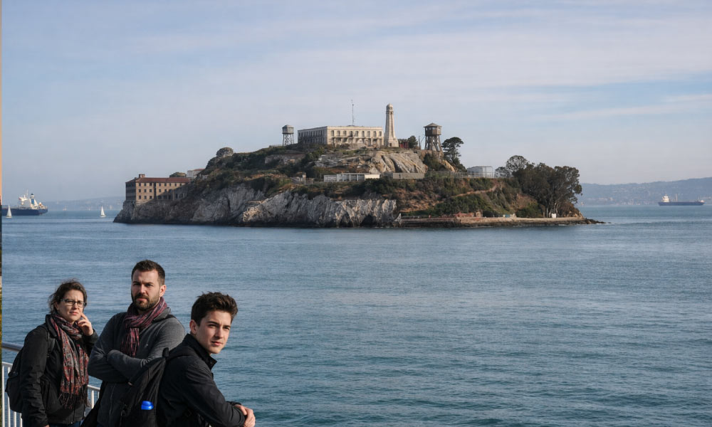 Visitors on a boat look out toward Alcatraz Island, one of the famous Historical Landmarks in the San Francisco Bay Area