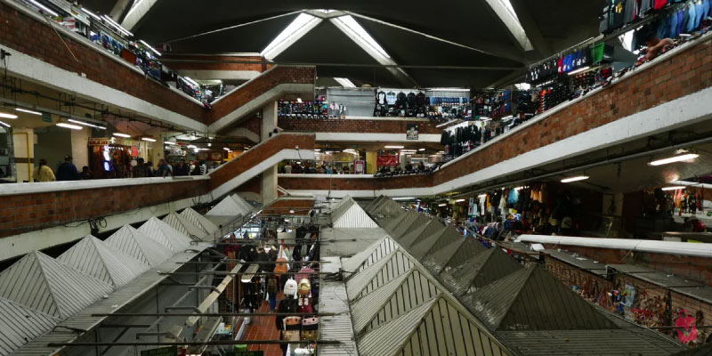 The interior of Mercado Libertad (San Juan de Dios) in Guadalajara, showing multiple levels of stalls under a distinctive geometric roof.
