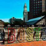 A colorful BOSTON sign sits near the historic Faneuil Hall Marketplace, highlighting one of the many must-see historical landmarks in Boston for visitors.