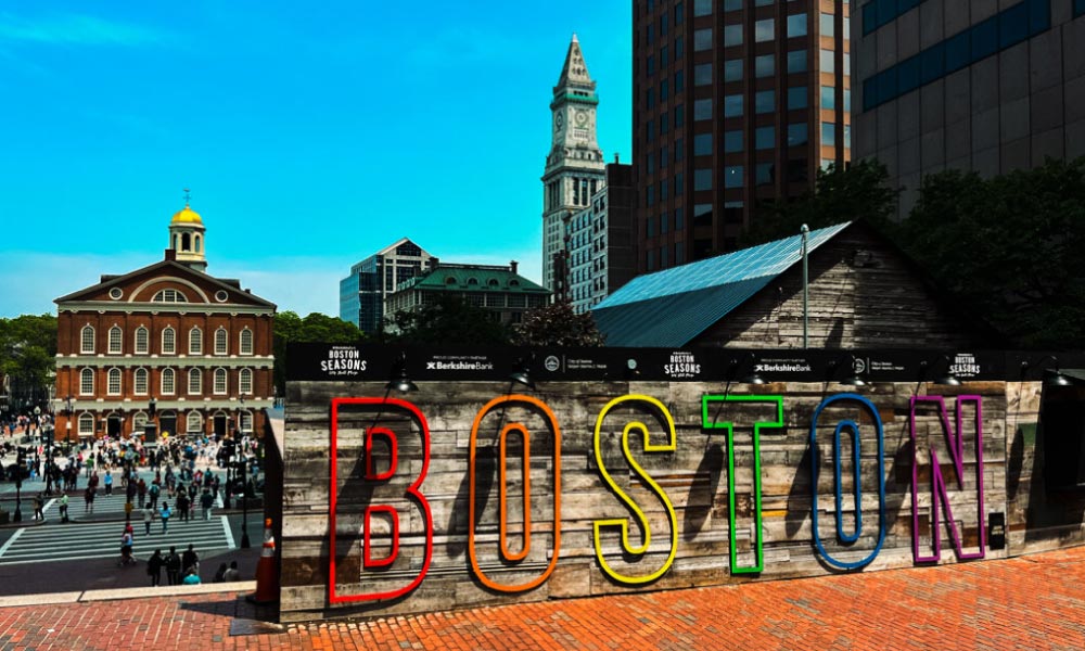 A colorful BOSTON sign sits near the historic Faneuil Hall Marketplace, highlighting one of the many must-see historical landmarks in Boston for visitors.