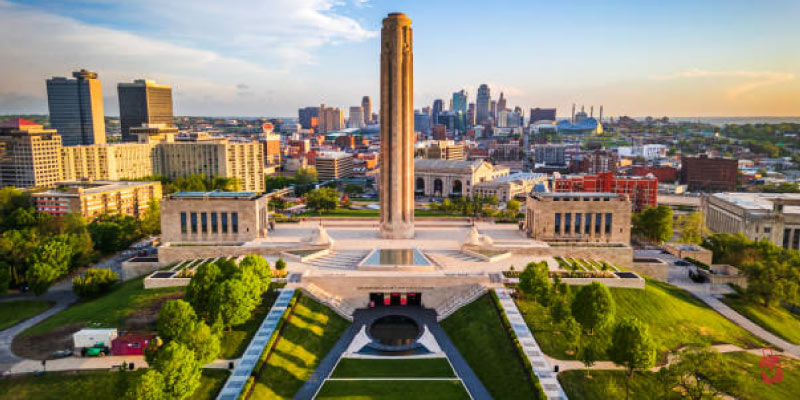 The National WWI Museum and Memorial stands tall in Kansas City, overlooking the city skyline at sunset.
