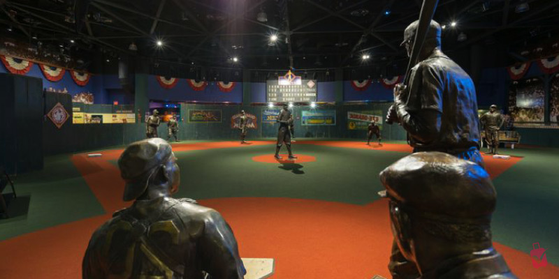The Negro Leagues Baseball Museum features bronze statues of baseball players on a green and red field.