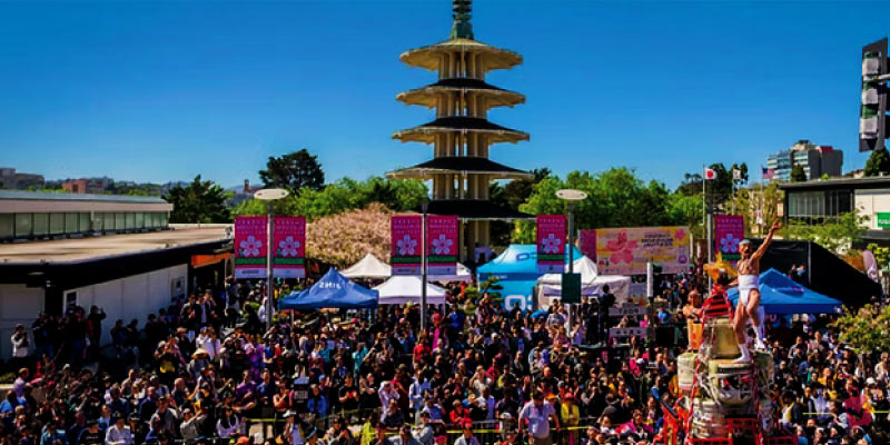Crowds celebrate the Northern California Cherry Blossom Festival in Japantown with the iconic Peace Pagoda in the background.