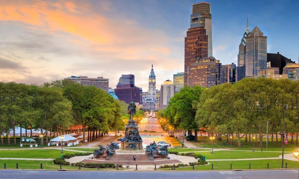 A sunset view over the Benjamin Franklin Parkway highlights surprising stories behind Philadelphia’s most famous historical landmarks.