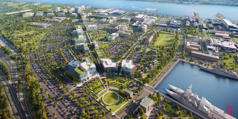 A digital rendering displays the green parks and modern waterfront buildings located at the Navy Yard in Philadelphia.